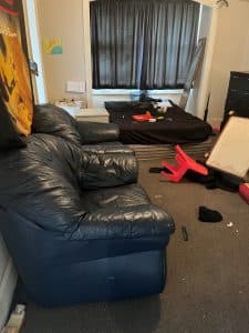 Before General Junk property cleanout - room packed with old belongings and furniture